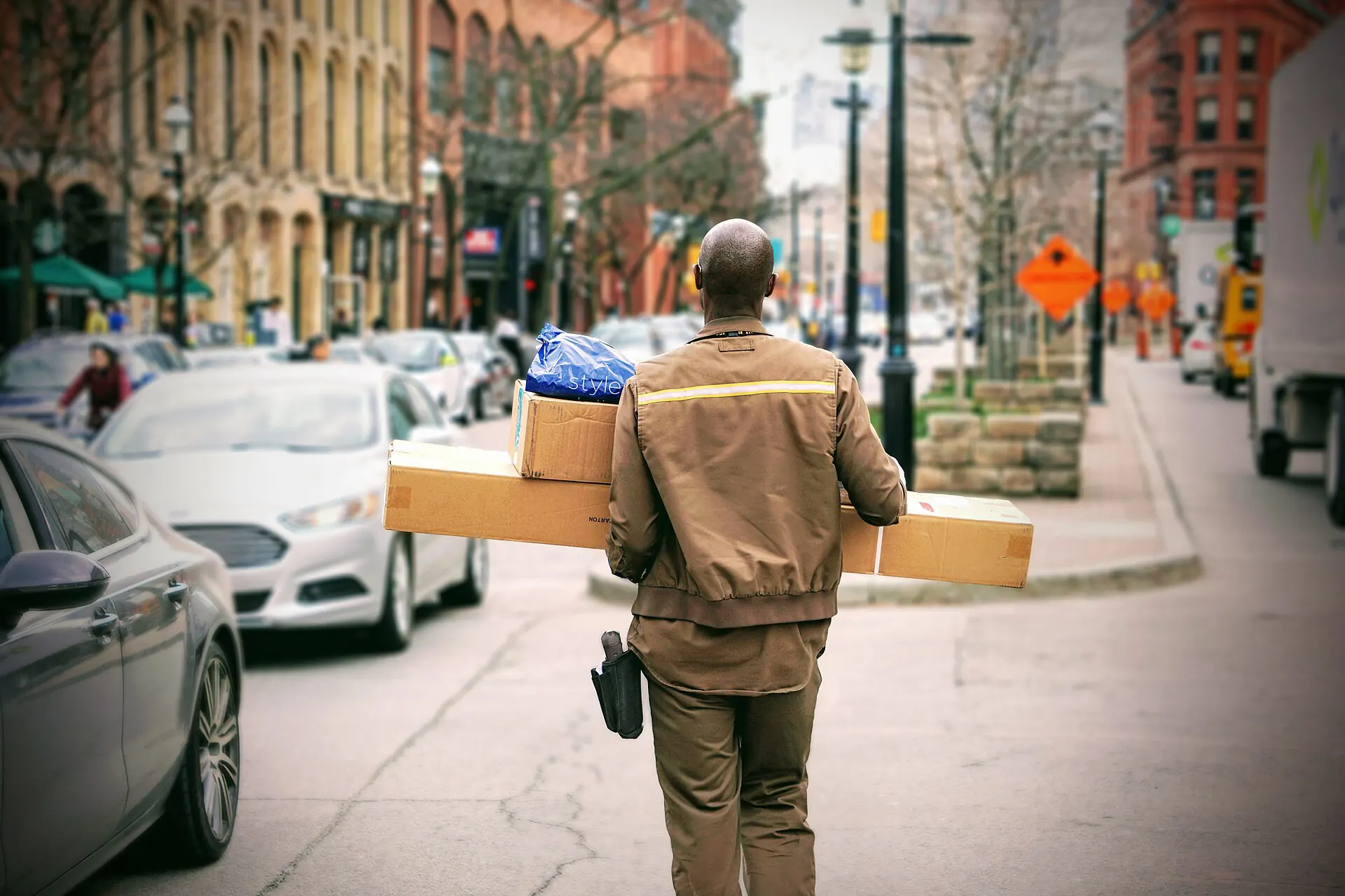 A driver carrying parcels across a street